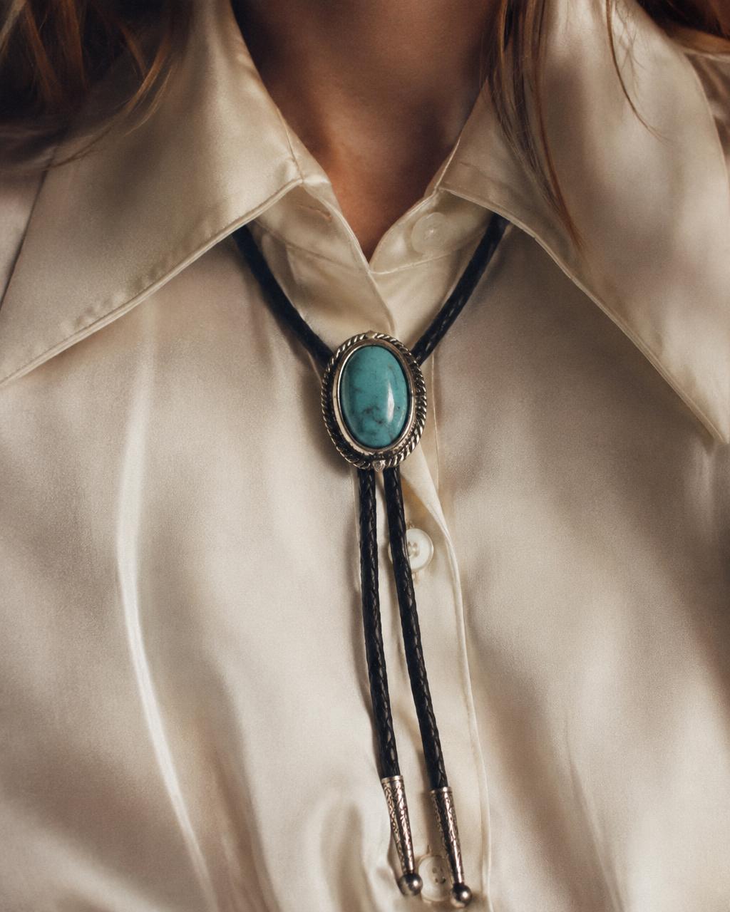 Vintage sterling silver bolo tie with oval turquoise stone on black leather cord