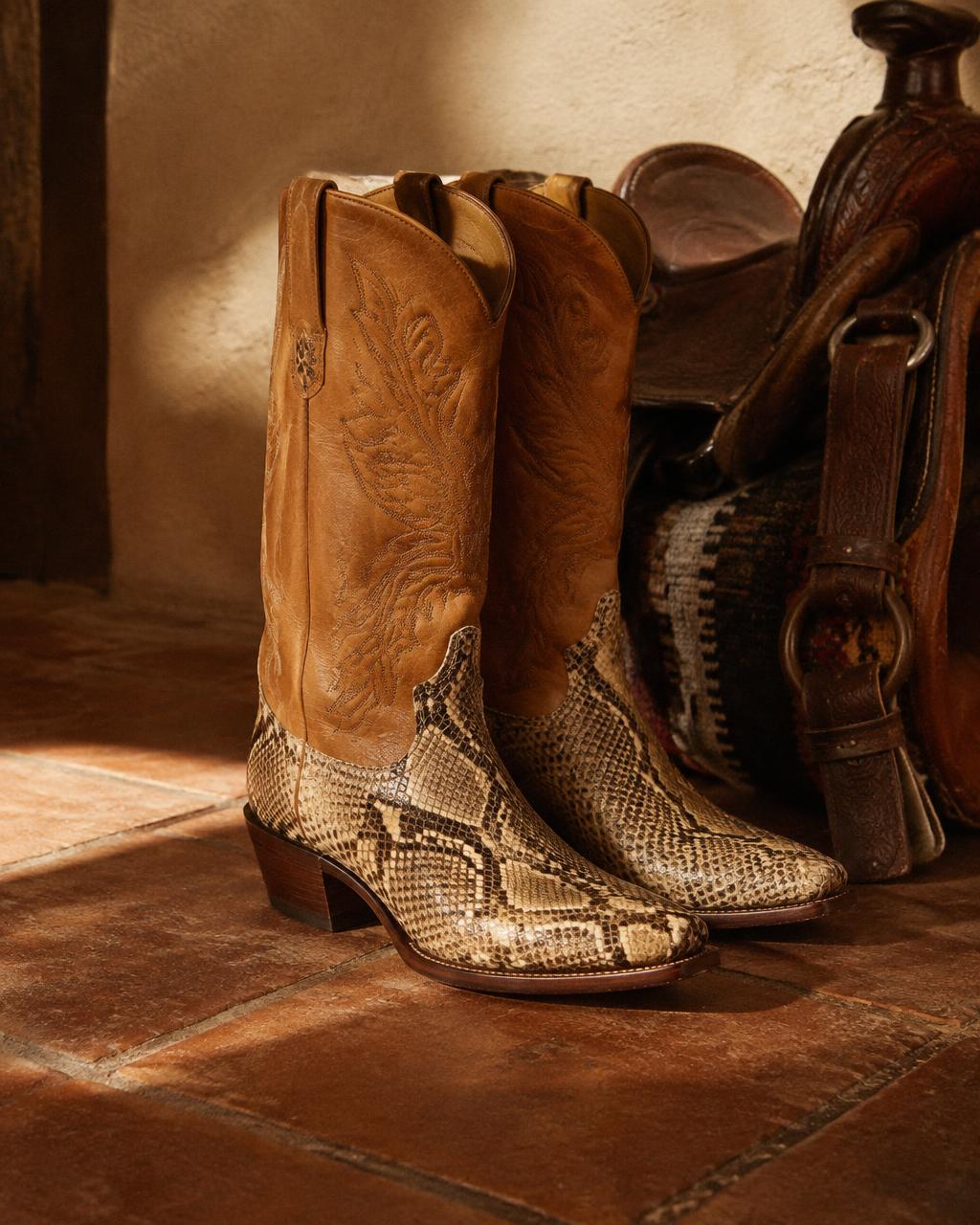 Vintage python cowboy boots beside a saddle